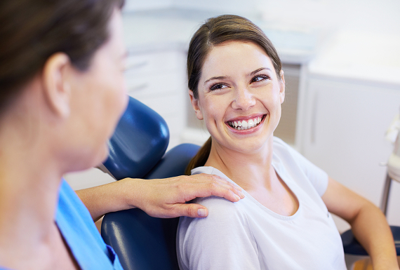 A patient smiling at dentist